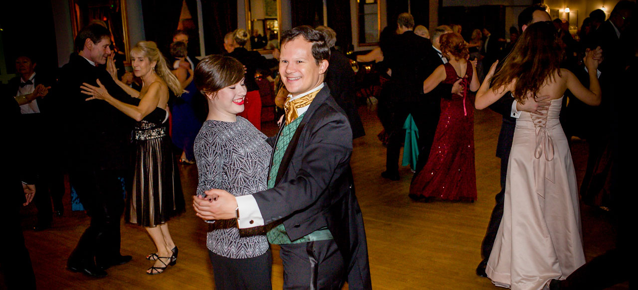 A couple enjoys dancing at the Glittering Christmas Ball